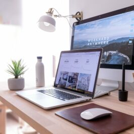 laptop, wireless mouse, and second monitor on a home desk