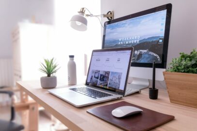 laptop, wireless mouse, and second monitor on a home desk